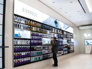A person wearing a VR headset engages with a virtual reality experience in a brightly lit Express store displaying phone accessories.