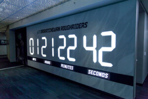 "A large digital countdown clock for the Saskatchewan Roughriders shows ""01 DAYS 21 HOURS 22 MINUTES 42 SECONDS."""