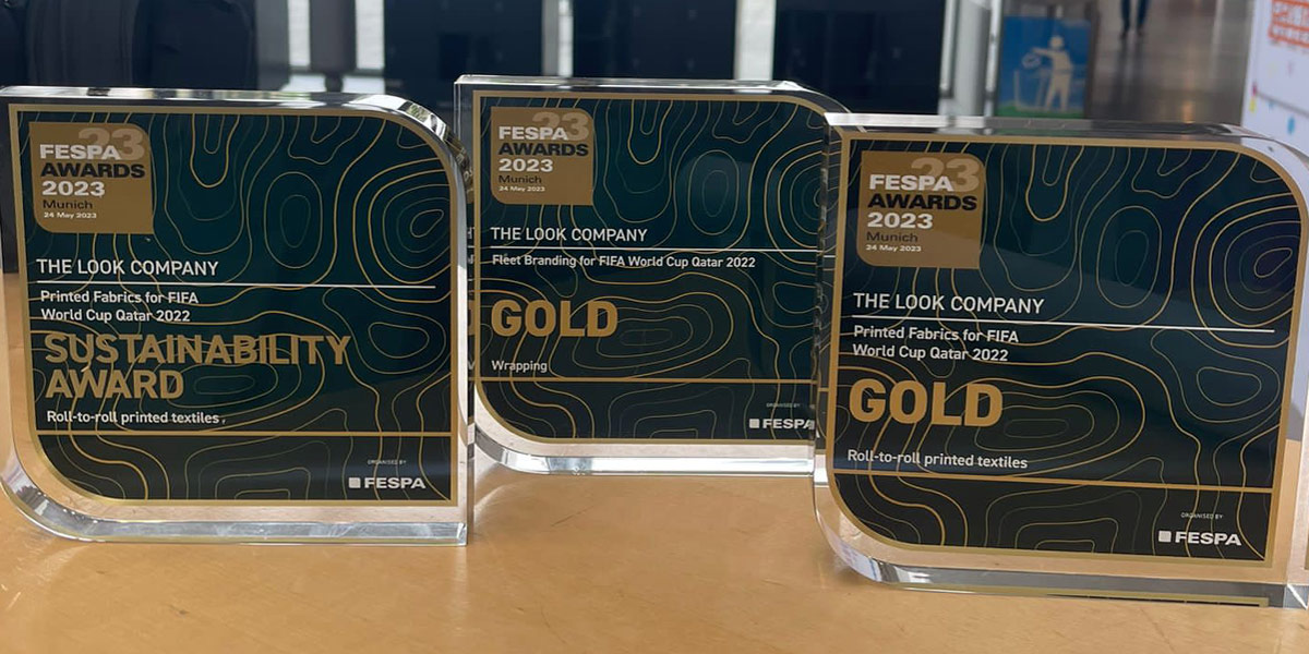 Three FESPA Awards 2023 trophies for The Look Company, including a Sustainability Award and two Gold Awards.