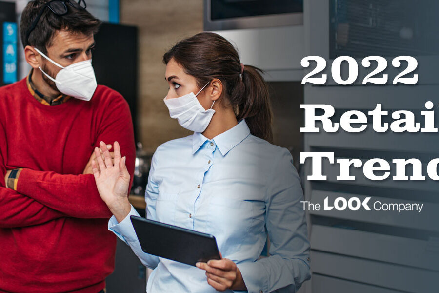 Two masked people, one holding a tablet, in a retail store with the overlay text ""2022 Retail Trends.""