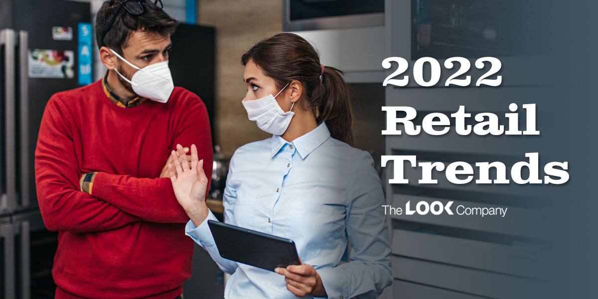 Two masked people, one holding a tablet, in a retail store with the overlay text ""2022 Retail Trends.""
