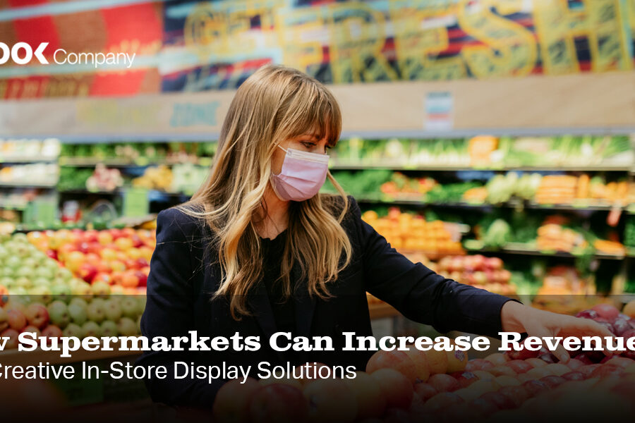 How Supermarkets Can Increase Revenue With Creative In-Store Display Solutions, featuring a woman in a mask selecting produce in a grocery store.