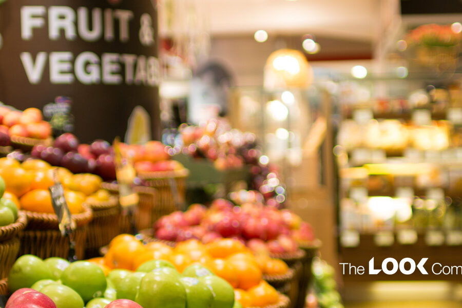 A vibrant grocery store display shows baskets brimming with green apples, oranges, and other fresh fruits, alongside a ""Fruit & Vegetable"" sign and ""The LOOK Company"" logo.