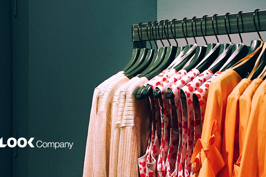 A clothing rack displaying beige, red polka dot, and orange garments, with ""The LOOK Company"" logo in the lower left.