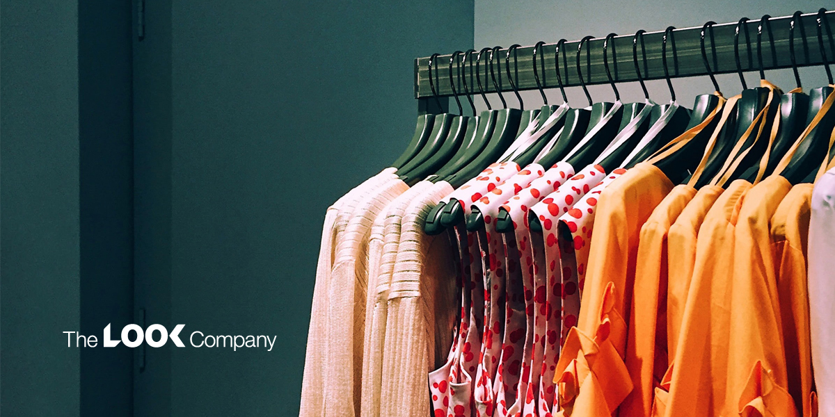 A clothing rack displaying beige, red polka dot, and orange garments, with ""The LOOK Company"" logo in the lower left.