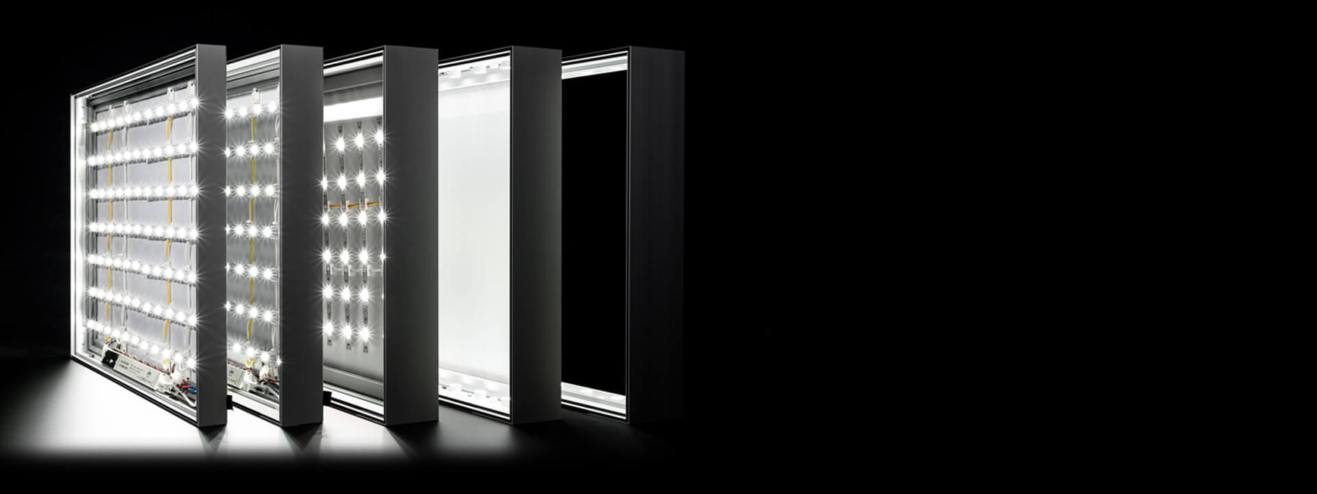 Disassembled layers of an LED lighting panel revealing illuminated LED strips, a white diffuser, and a dark frame.