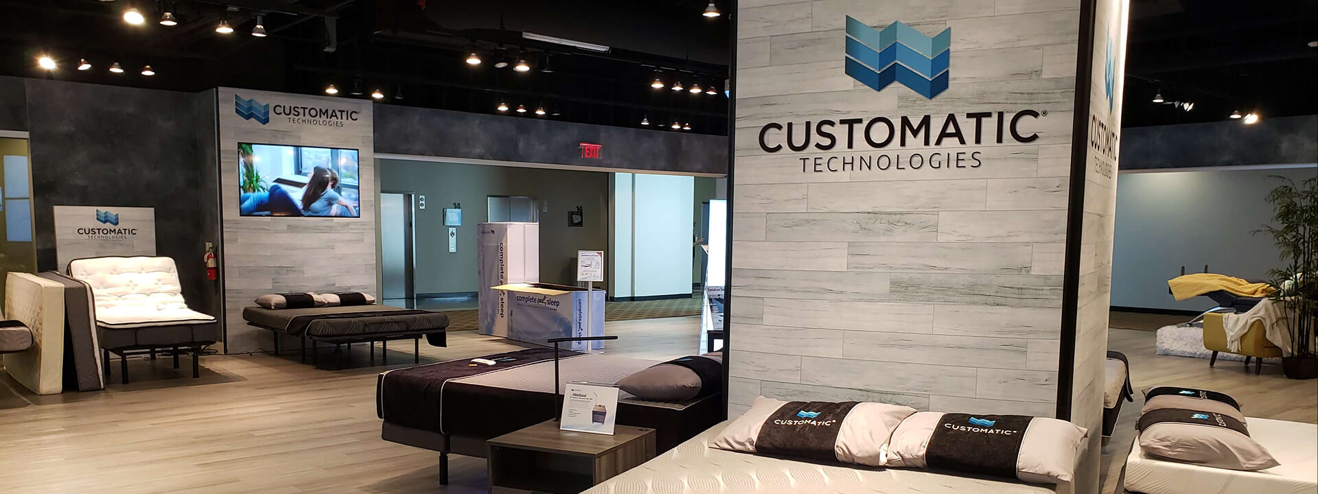 A Customatic Technologies showroom displaying various mattresses and adjustable beds.