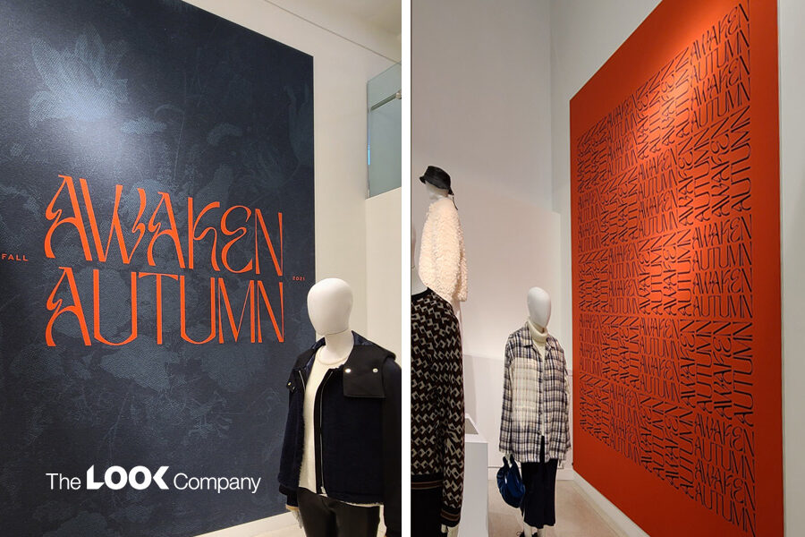Two retail displays with mannequins and ""AWAKEN AUTUMN"" branding: a dark grey banner with orange text on the left, and an orange wall with black patterned text on the right.