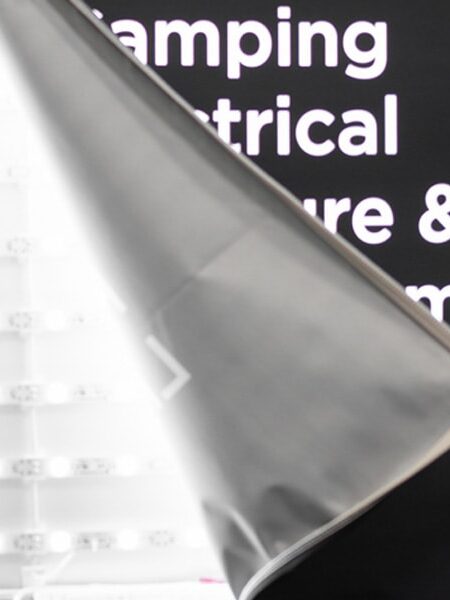A hand peels back a display graphic, revealing rows of bright LED lights behind white text like ""Camping Electrical"" and ""Storage & Comfort,"" with The LOOK Company logo.